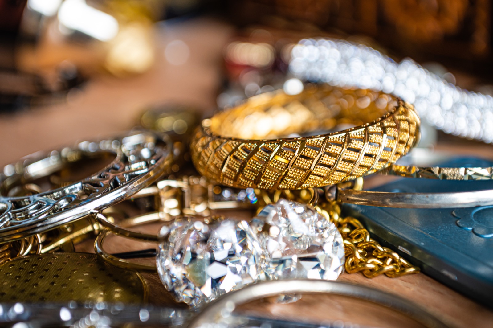Close-up of vintage and antique gold and silver jewelry, bangles, chains, and diamonds